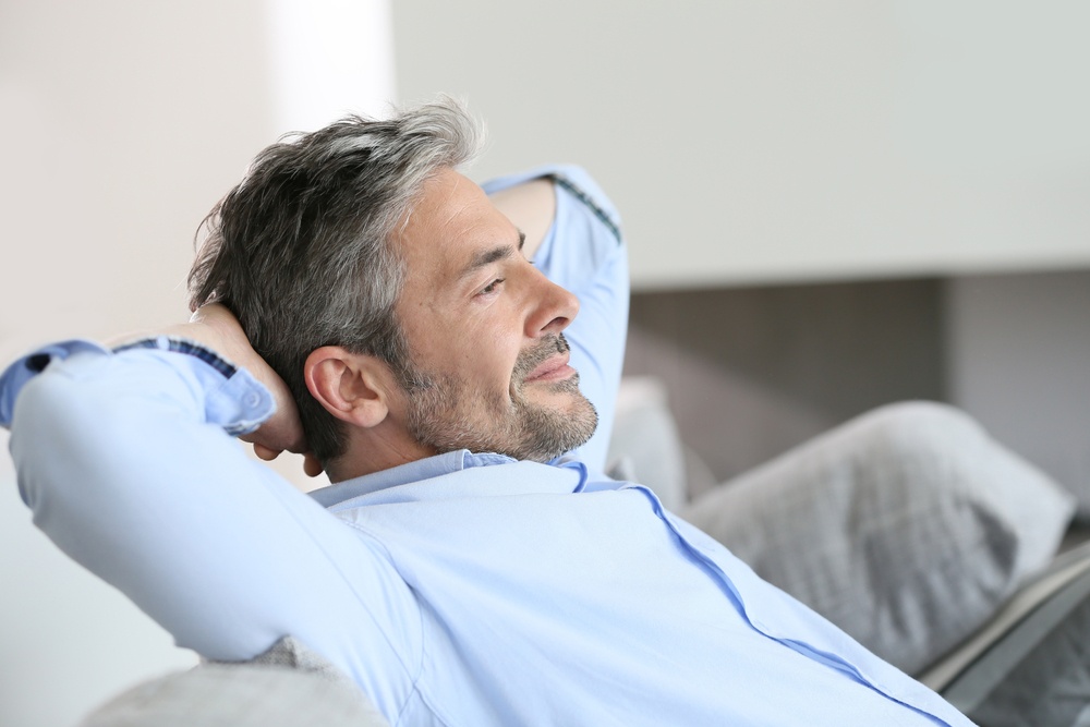 Middle-aged man having a restful moment relaxing in sofa.jpeg